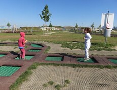 Zwei Kinder bewegen sich über eine Trampolinanlage im Motorikpark und fördern spielerisch Koordination sowie Gleichgewicht.