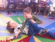 Kinder üben im Rahmen eines Erste-Hilfe-Workshops die stabile Seitenlage und lernen grundlegende Maßnahmen zur Hilfeleistung.