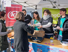Helfer*innen der youngCaritas und Katholischen Jugend nehmen gespendete Produkte am Sammelstand entgegen.