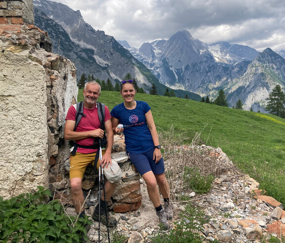 Ein Mann und eine Frau deponieren einen bemalten Stein bei einer Ruine 